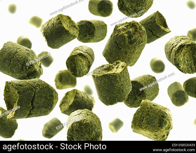 Green granulated hops levitate on a white background