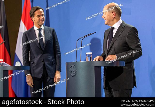 13 January 2022, Berlin: German Chancellor Olaf Scholz (r, SPD) and Mark Rutte, Prime Minister of the Netherlands, stand together during a press conference...