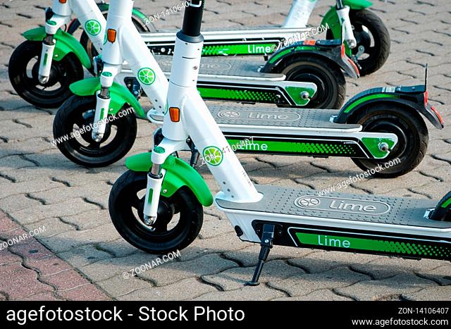 Berlin, Germany - June, 2019: Electric E scooter , escooter or e-scooter of the ride sharing company LIME on sidewalk in Berlin, Germany