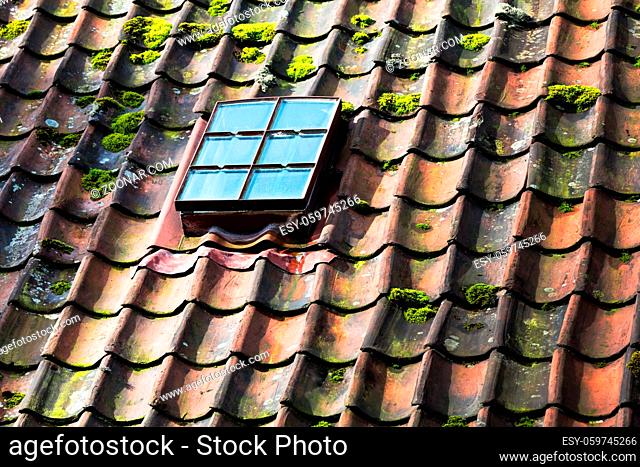 skylight on old ceramic tiles house roof