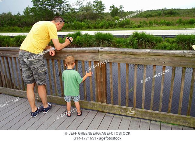 Florida, The Everglades, Big Cypress National Preserve, Tamiami Trail, Oasis Visitors Center, nature boardwalk, man, father, boy, water, learning, bonding