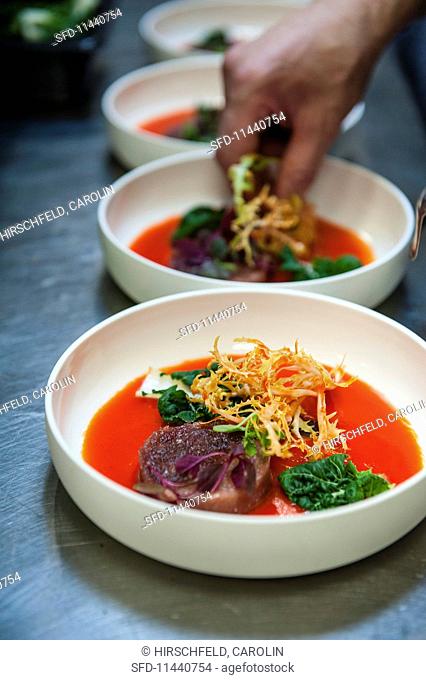 Tuna and hamachi tatar in gazpacho with baby bok choy and frisee lettuce