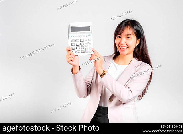 Tax day concept. Woman confident smiling holding electronic calculator, Portrait excited happy Asian young female studio shot isolated on white background