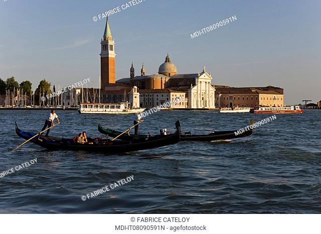 Gondolas with tourists and in the background the San Giorgio Maggiore Island, the church and the campanile