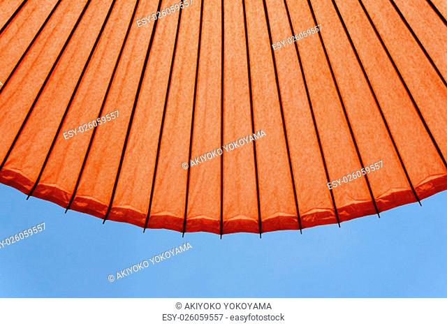 Japanese red umbrella against clear blue sky