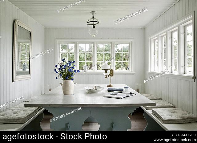 Summer cottage of Jes & Wenche Gerlach, North Zealand. Dining area with table & benches made for the space by a local carpenter, seats fourteen