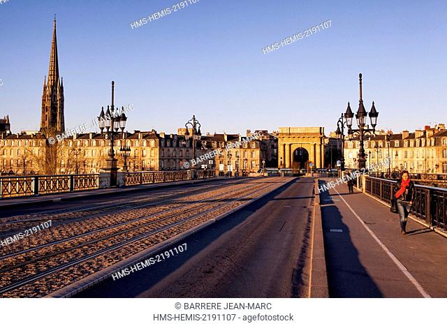 France, Gironde, Bordeaux, area listed as World Heritage by UNESCO, Pont de Pierre on the Garonne River, in the background Saint Michel church and the gate of...