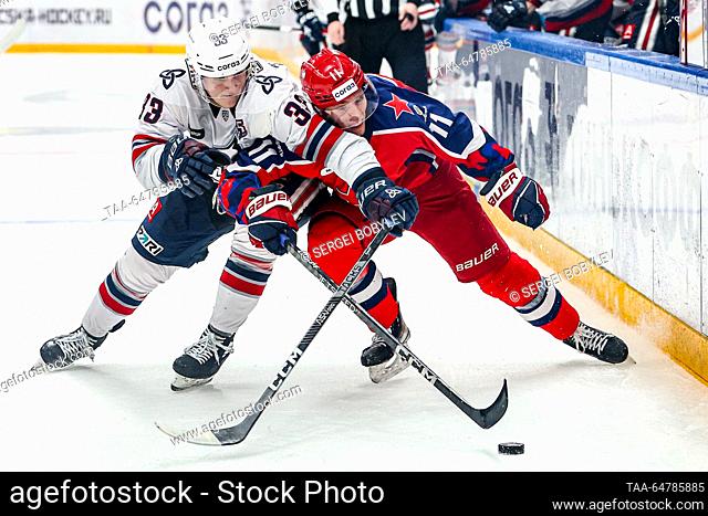 RUSSIA, MOSCOW - NOVEMBER 13, 2023: Neftekhimik Nizhnekamsk's Mikhail Sidorov (L) and CSKA Moscow's Vitaly Abramov fight for the puck in their 2023/24 KHL...