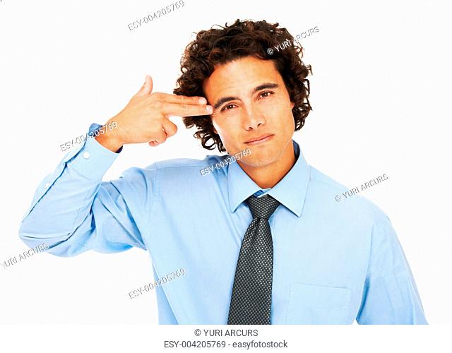 Portrait of a young businessman using his hand as a gun and placing at his temple