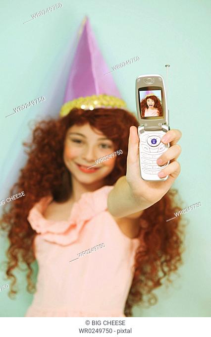Young girl using a mobile phone with camera