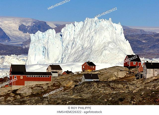 Greenland, Angmassalik Region, Tiniteqlaaq, Huge Iceberg behind the Inuit Village