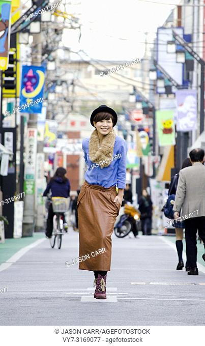 Japanese Girl poses on the street in Shimo-Kitazawa, Japan. Shimo-Kitazawa is a town located in Tokyo