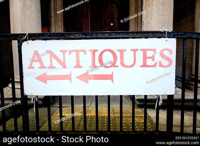antiques sign on old iron railings in Ulverston UK