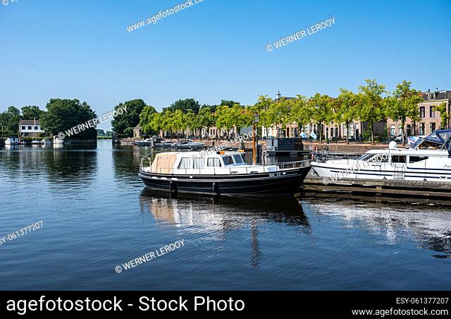Blokzijl, Overijssel, The Netherlands - Pleasure harbor and banks of the canal against blue sky