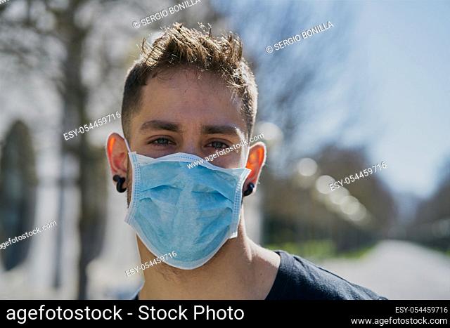 Caucasian male with medical masks as a defense against a virus. Coronavirus concept