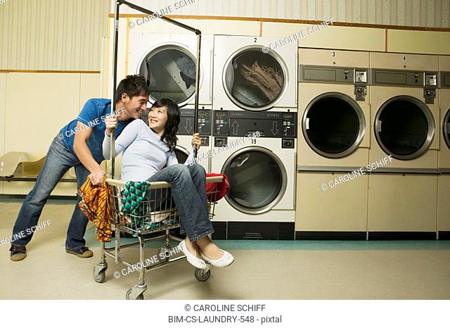 Asian couple in Laundromat