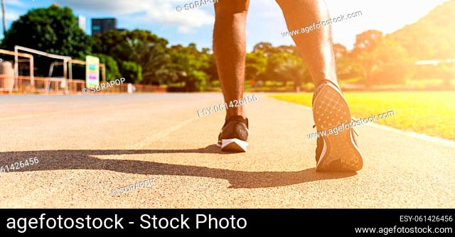 Asian young athlete sport runner black man wear feet active ready to running training at the outdoor on the treadmill line road for a step forward