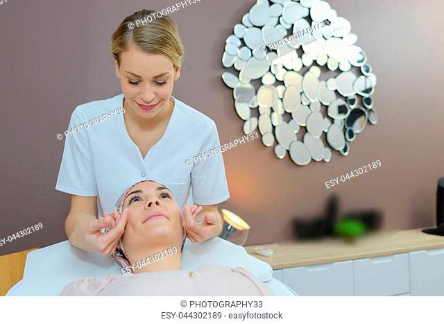 young beautiful woman in spa environment taken care of