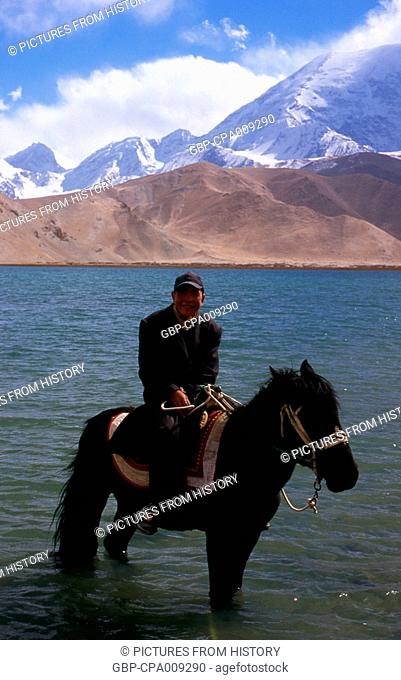 China: Kirghiz horseman at Lake Karakul on the Karakoram Highway, Xinjiang