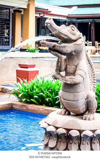 Close up statue of crocodile spray water