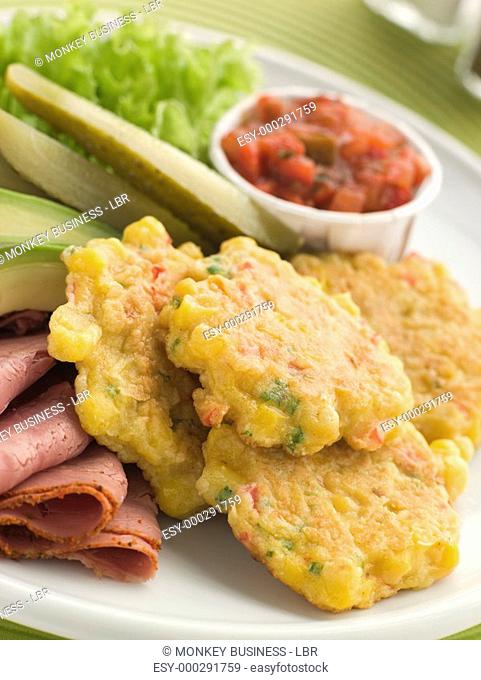 Sweet corn Fritters with Salsa Gherkins Avocado and Pastrami