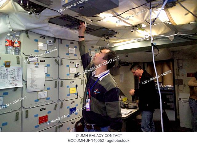 JAXA astronaut Soichi Noguchi (foreground), STS-114 mission specialist, participates in a long duration integrated simulation for the return to flight mission...