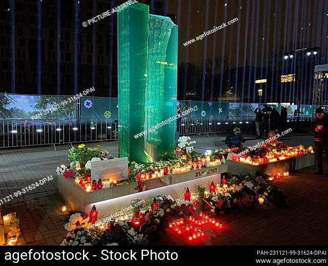 21 November 2023, Latvia, Riga: A number 54 made of candles stands in front of the memorial to the victims of the Riga collapse tragedy