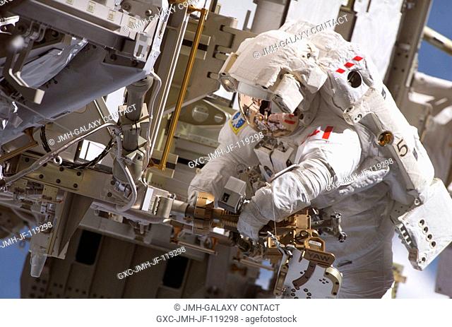 Canadian Space Agency astronaut Steven G. MacLean, STS-115 mission specialist, performs a task to relocate articulating portable foot restraints (APFR) during...