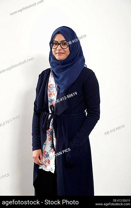 Portrait confident teenage girl wearing hijab