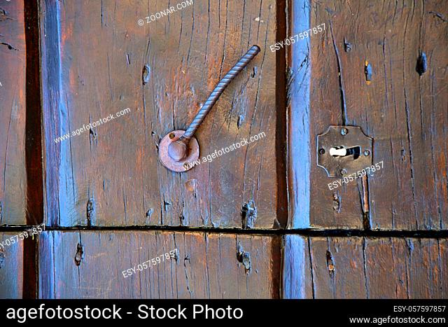 varese abstract rusty brass brown knocker in a door closed wood mornago lombardy italy