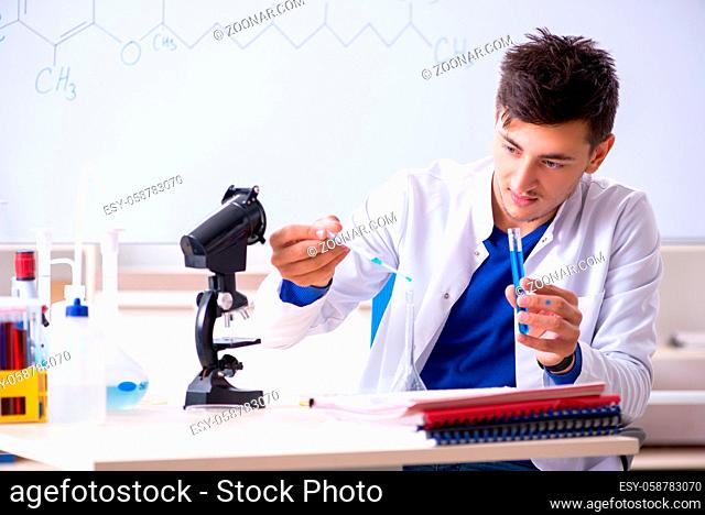 Young chemist sitting in the lab