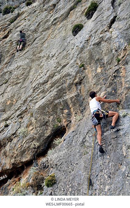 Greece, Kalymnos, two climbers in rock wall