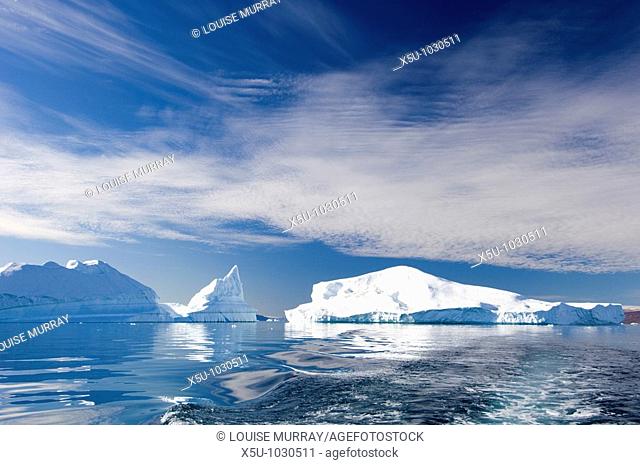 Icebergs reflected in the arctic ocean, Inglefield Fjord near Qaanaaq, Greenland