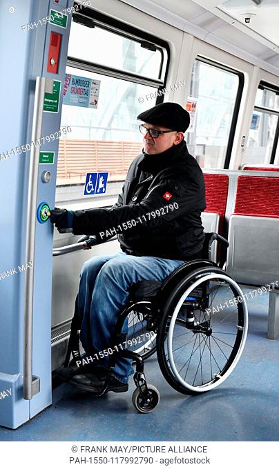 A Wheelchair user in a train, Germany, city of Hamburg, 05. March 2019. Photo: Frank May (model released) | usage worldwide