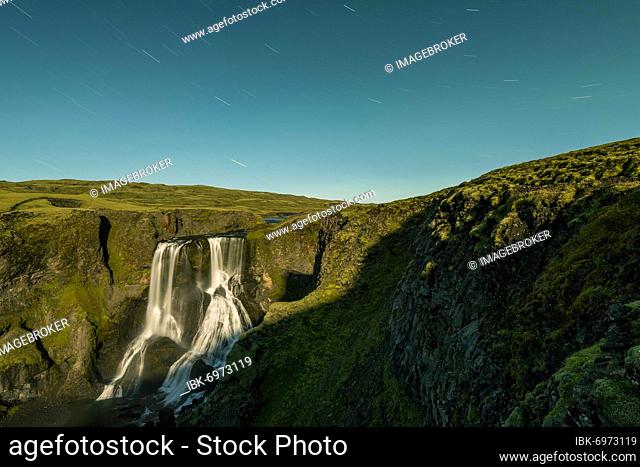 Star trails, Fagrifoss waterfall, Geirlandsá river, Lakagigar region, Vatnajökull National Park, Highlands, Iceland, Europe