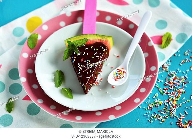 Watermelon pieces with chocolate glaze and colorful sugar sprinkles