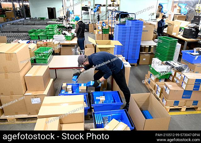 07 May 2021, Baden-Wuerttemberg, Stuttgart: Bicycle parts are picked in a warehouse of the company Paul Lange, the German importer of the Japanese bicycle...