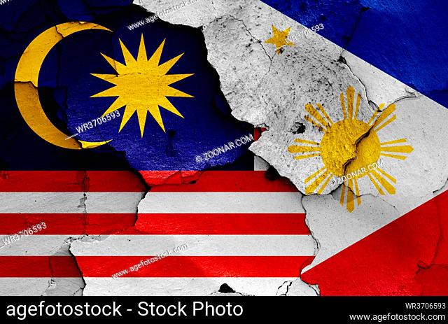 flags of Malaysia and Philippines painted on cracked wall