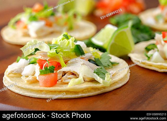 A close up photo of finished street tacos in a studio setting