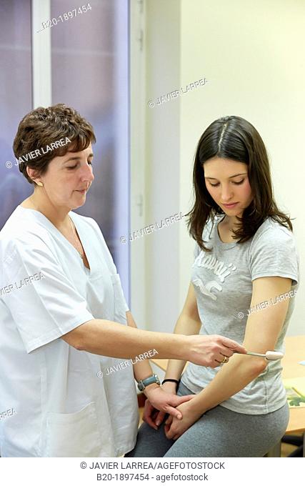Doctor checking triceps reflex, Physiotherapy medical center, Donostia, San Sebastian, Gipuzkoa, Basque Country, Spain