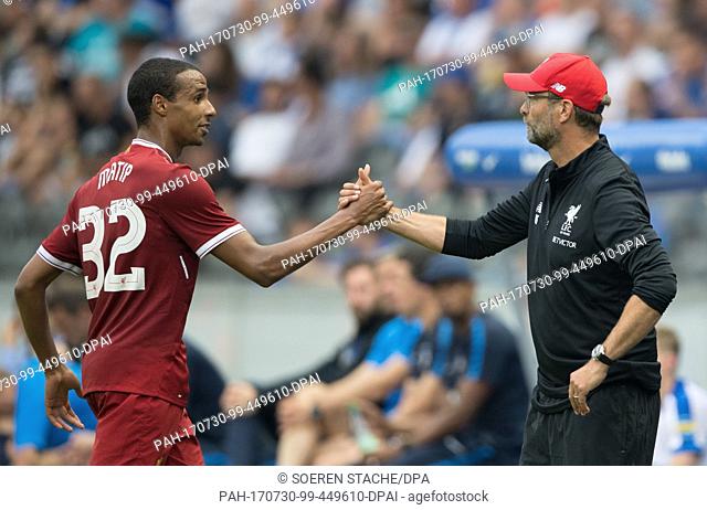 Liverpool's Joel Matip (l) and coach Juergen Klopp shake hands during the international club friendly soccer match between Hertha BSC and FC Liverpool in the...