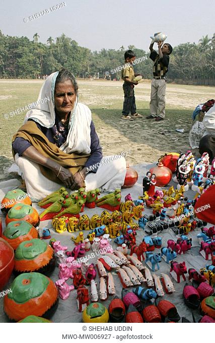 An old woman selling earthen toys at a fair during the Eid-ul-Adha in a village Mayshaghuni, Rupsha, Khulna, Bangladesh January 01