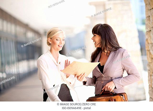 Businesswomen talking in walkway