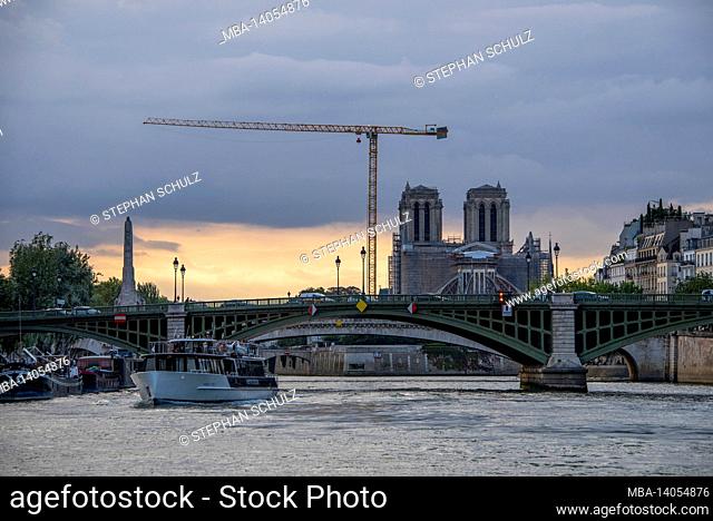 france, paris, scaffolded notre dame cathedral at sunset, reconstruction after the fire in april 2019, major construction site