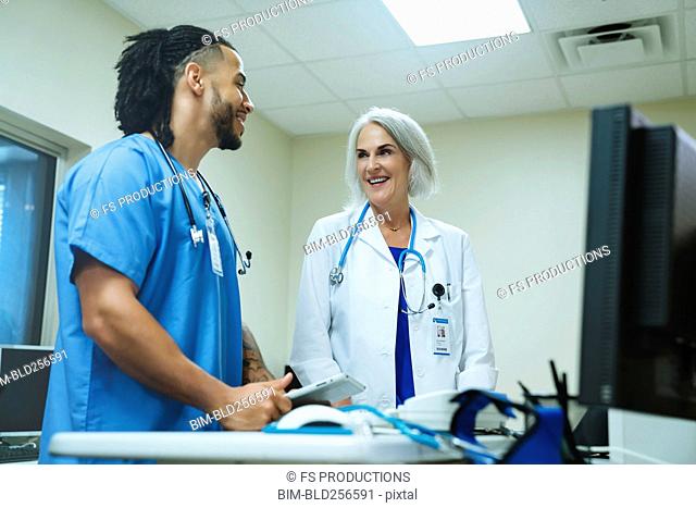 Smiling doctor and nurse talking