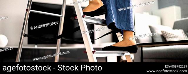 Ladder Safety. Woman Climbing Step Ladder In Shoes