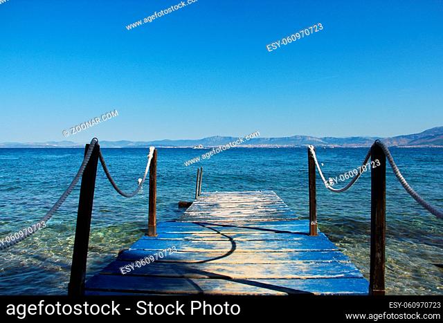 Wooden jetty over turquoise sea water, Supetar, Brac island, Croatia