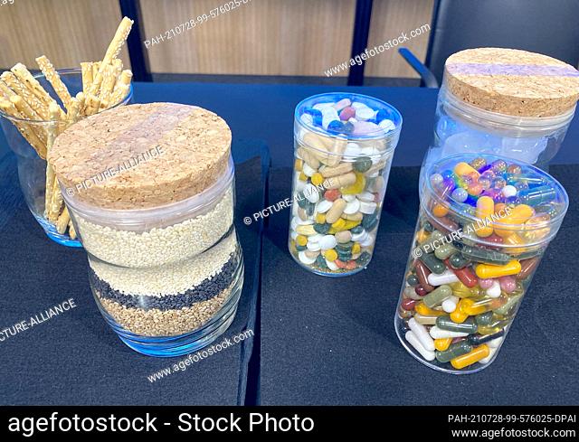28 July 2021, Baden-Wuerttemberg, Stuttgart: Various food supplements in tablet or capsule form stand on a table at a food monitoring press conference