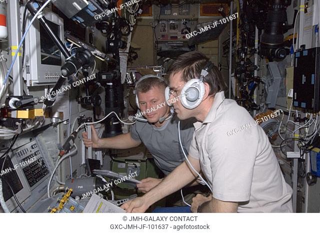 Russian cosmonauts Yuri Malenchenko (foreground) and Oleg Novitskiy, both Expedition 33 flight engineers, monitor data at the manual TORU docking system...