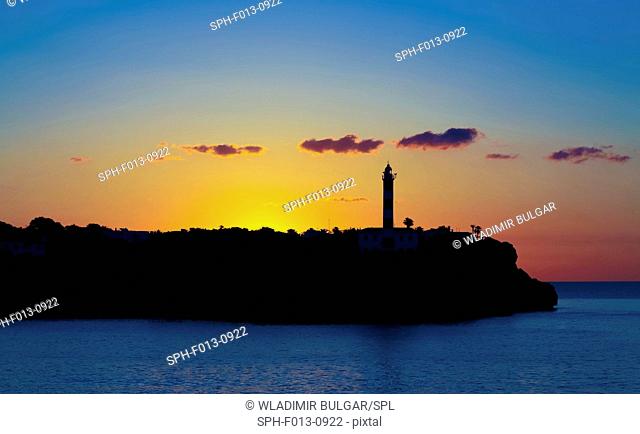 Silhouette of a lighthouse on the coast